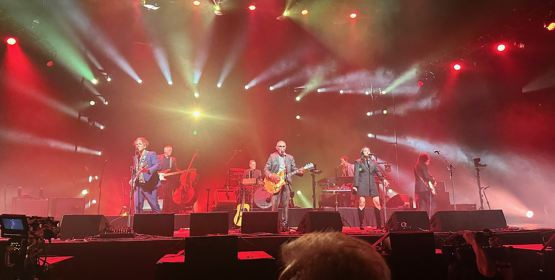 Paul Kelly with his band, playing Rod Laver Arena in September 2025