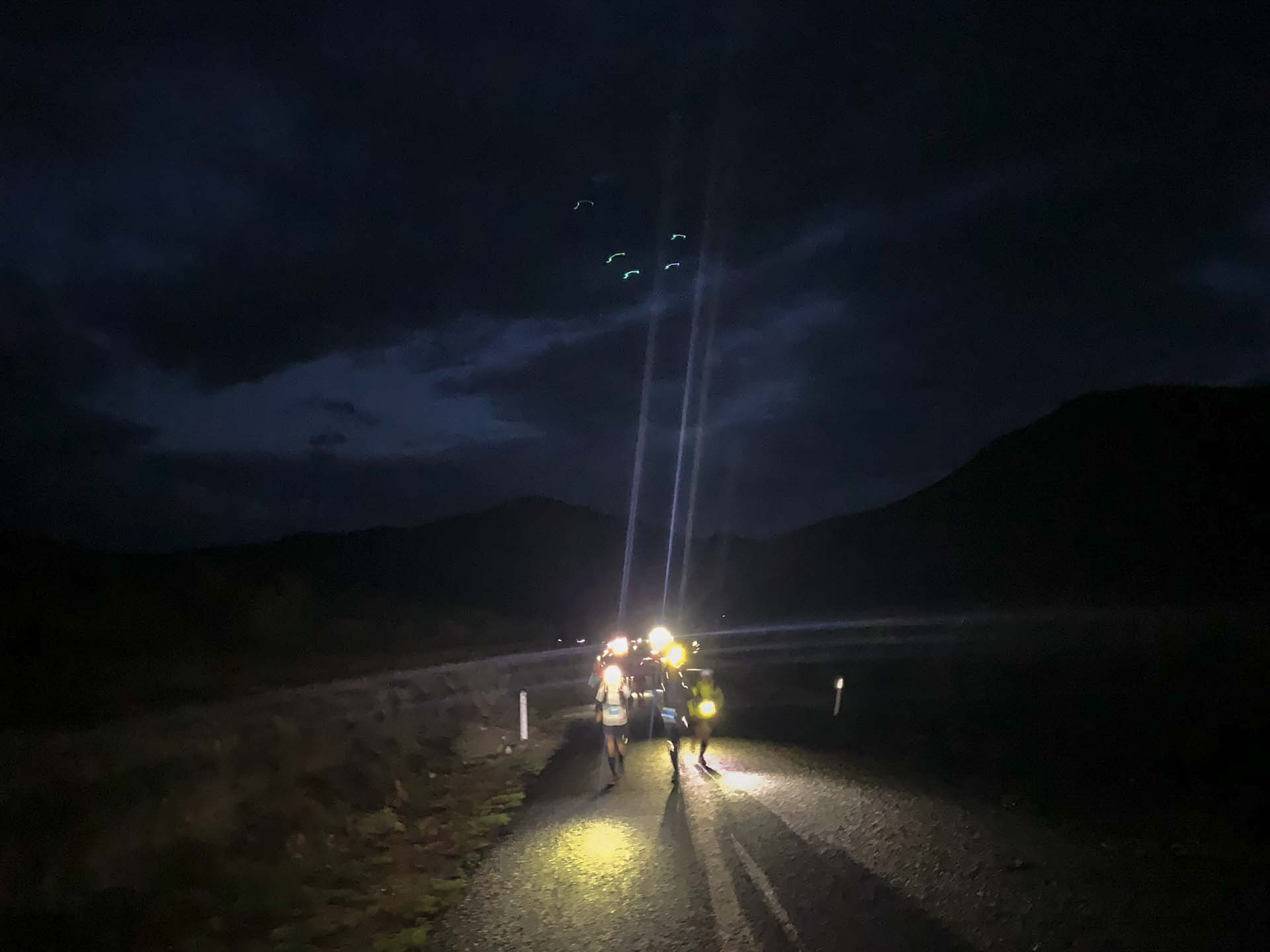 Climbing to Telegraph Saddle, guided by headlamps